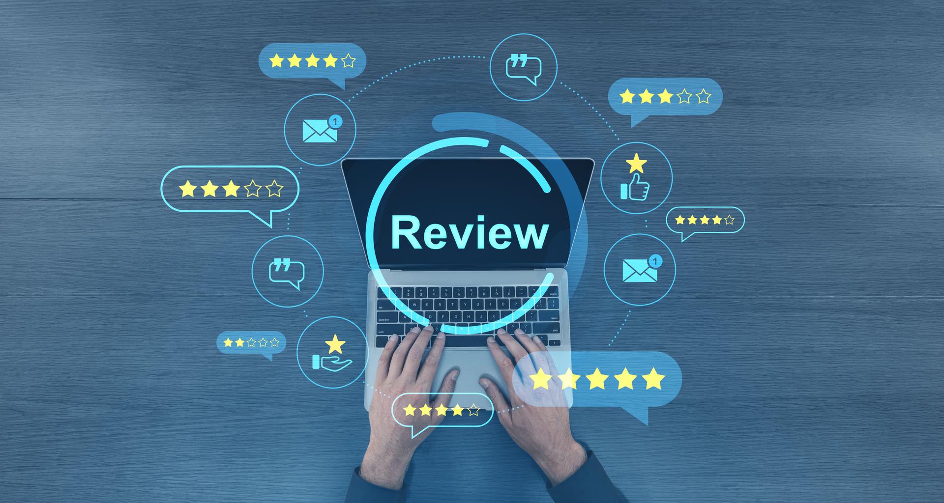 Customer review concept with laptop and digital rating icons on blue wood background.
